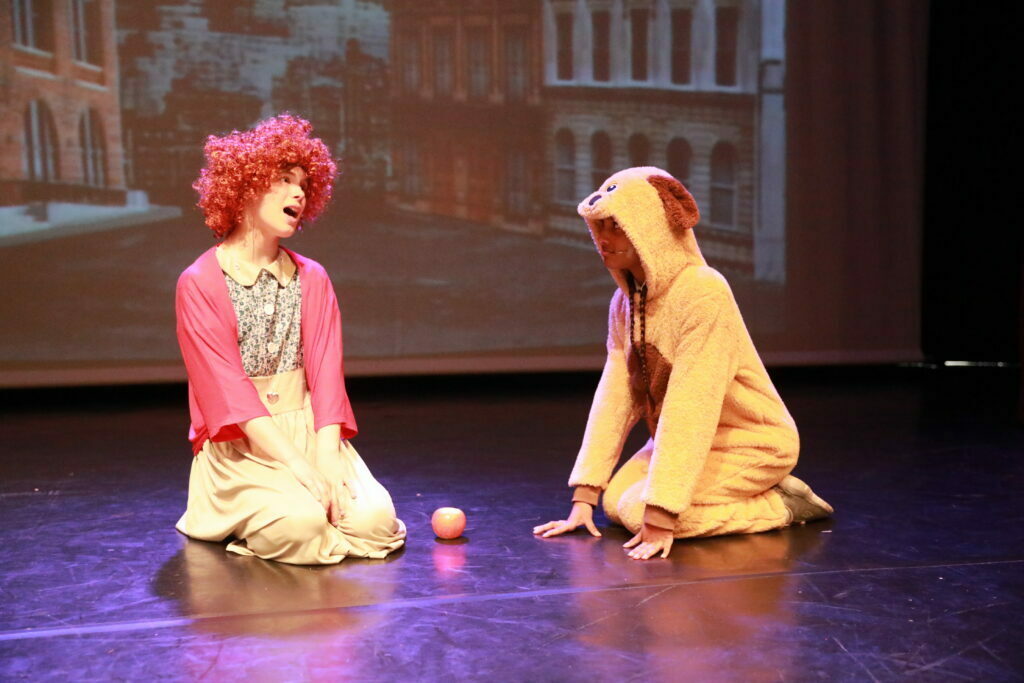 Our performing arts classes teach singing, dancing and acting. Our students performed Annie Junior in July 2022. This image shows Annie singing to her dog, Sandy, and is here to demonstrate the kind of exciting performance opportunities all our students get.